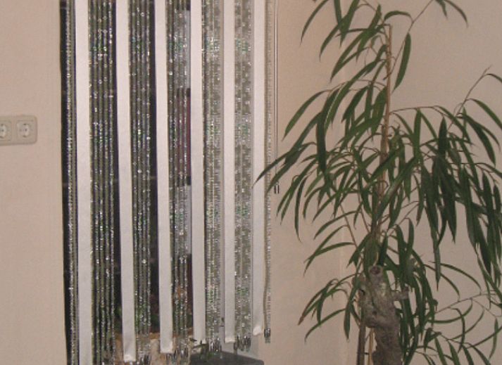 Cozy dining room in Holiday Home in Wenum Wiesel, Veluwe, with wooden table and chairs.