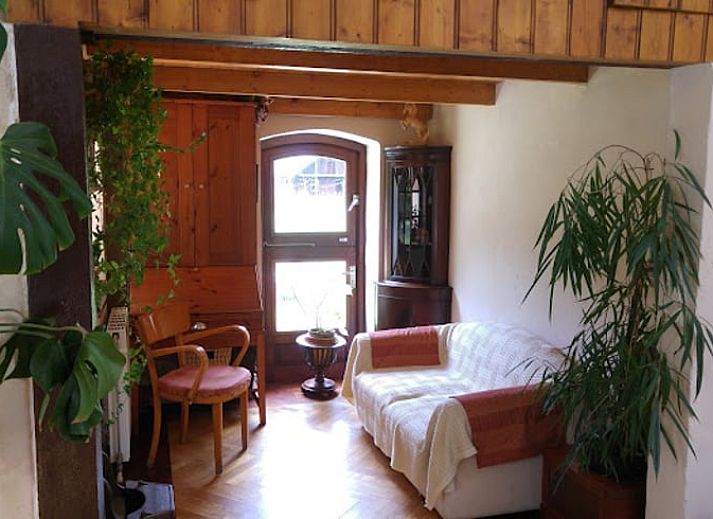 Cozy sitting area in Holiday Home in Wenum Wiesel, Veluwe, with sofa and wood stove.