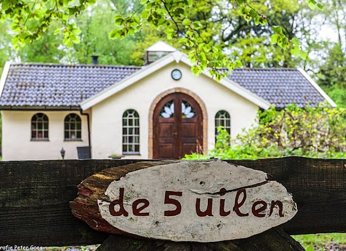 Cozy sitting area in Holiday Home in Wenum Wiesel, Veluwe, with sofa and wood stove.