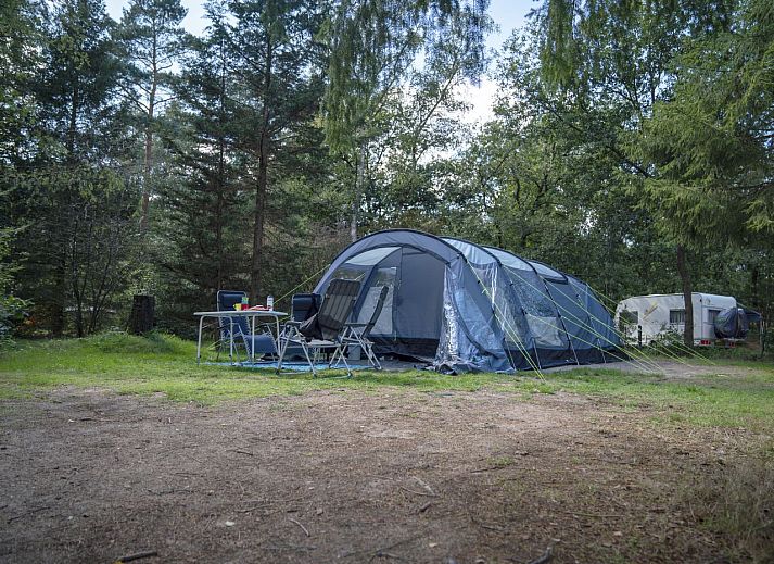 Enjoy nature at Rabbit Hill, Comfort camping site C10+ in Nieuw Milligen, Veluwe, with a spacious tent and cozy outdoor seating area.