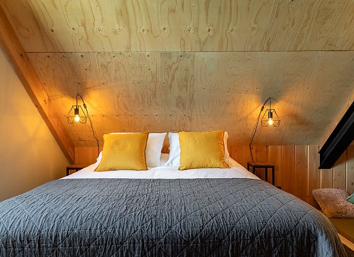 Landhaus in Veessen, Veluwe, Gelderland, Essecke mit Holztisch und stimmungsvoller Beleuchtung.