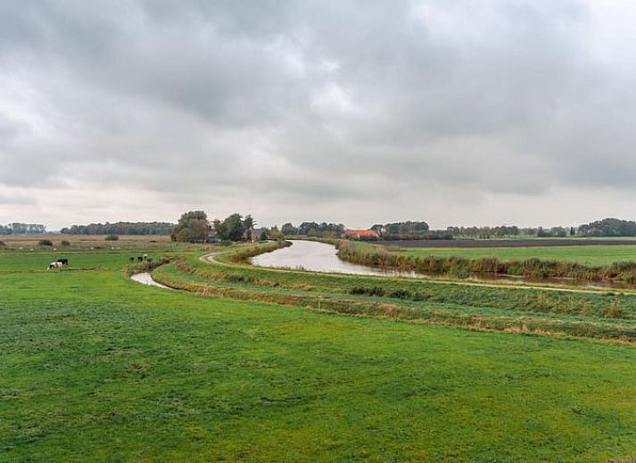 Attractive bedroom in Holiday cottage in Schildwolde, northeastern Groningen, with comfortable bed and country mural.