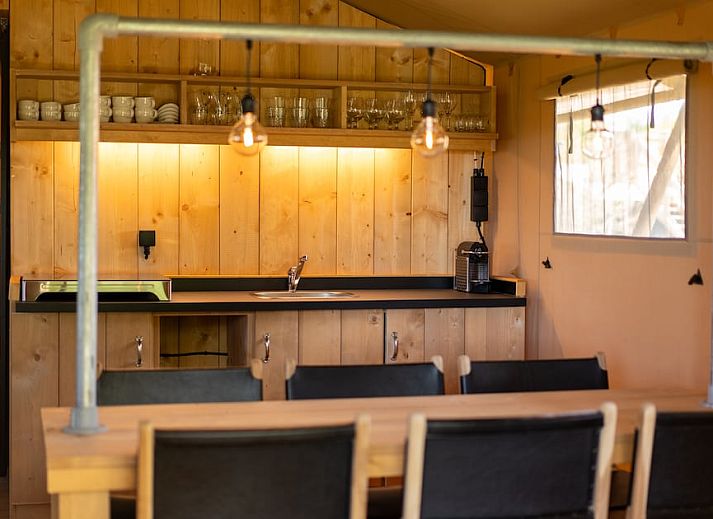 Modern bathroom in Safari Tent 8, a glamping lodge in Vierhuizen, Northwest Groningen, with wooden interior and luxury amenities.