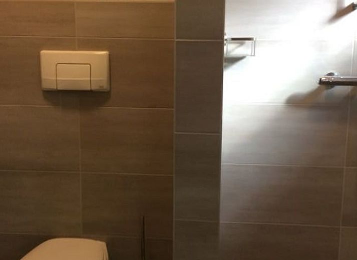 Attraktives Schlafzimmer im Huisje in Ter Apel, einem Ferienhaus im Suedosten von Groningen mit rustikalen Holzbetten und warmen Akzenten.