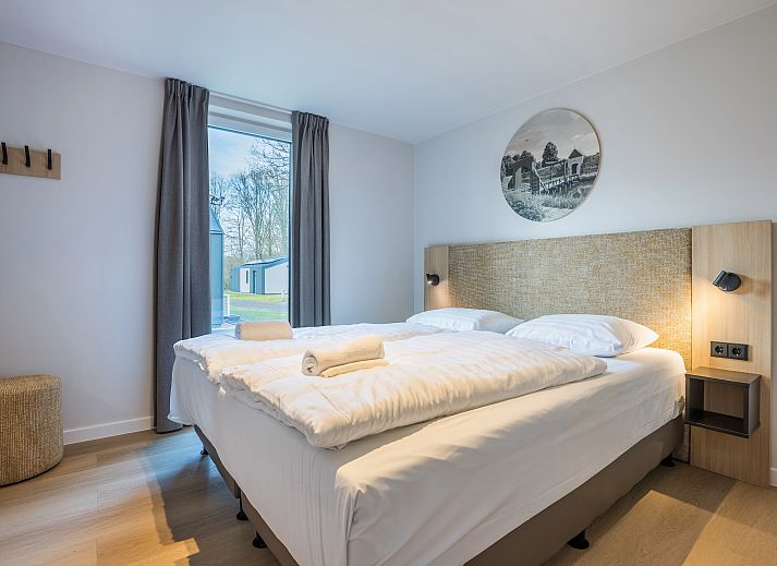 Bright living room of vacation home 4-person house 4C in Sellingen, overlooking nature.