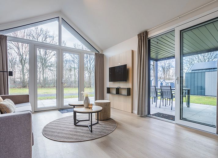 Bright living room of vacation home 4-person house 4C in Sellingen, overlooking nature.