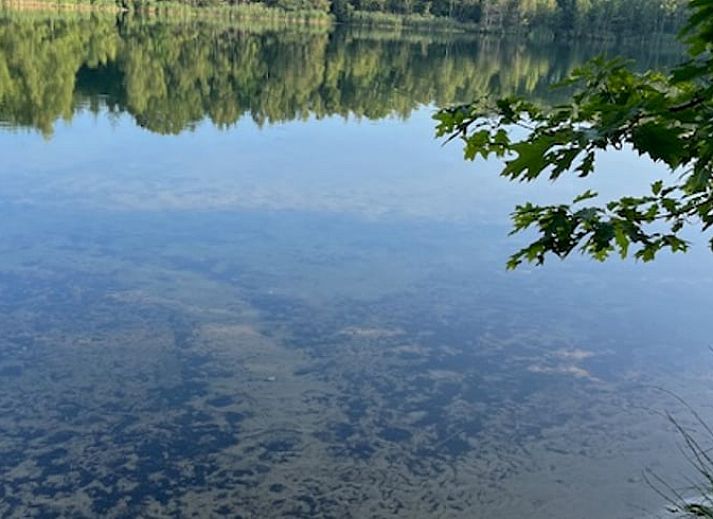 Dining area with wood stove in Cottage in Onstwedde, a cozy vacation home in Groningen.