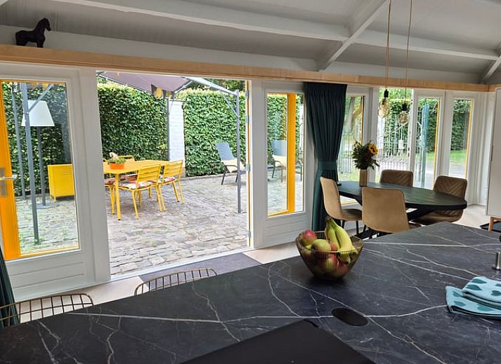 Modern kitchen and dining area in Holiday Home in Nederweert-Eind, Central Limburg, with stylish decor and natural light.