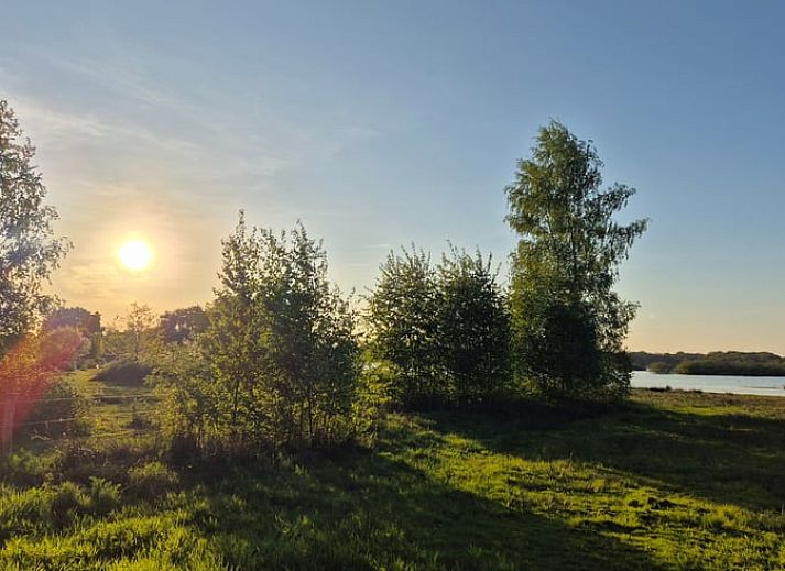 Modern kitchen and dining area in Holiday Home in Nederweert-Eind, Central Limburg, with stylish decor and natural light.