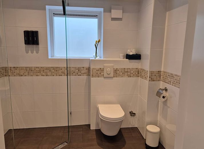 Modern kitchen and dining area in Holiday Home in Nederweert-Eind, Central Limburg, with stylish decor and natural light.