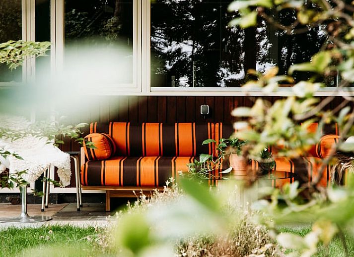 Cozy living room in Holiday Home in Haelen, Central Limburg, overlooking the green surroundings.