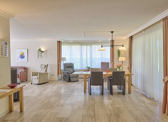 Cozy living room of Lionshuis vacation home in Panningen, Limburg with comfortable seating.