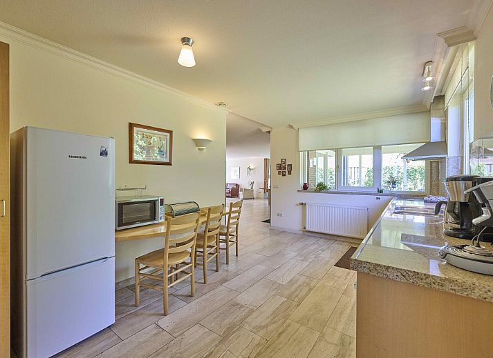 Cozy living room of Lionshuis vacation home in Panningen, Limburg with comfortable seating.