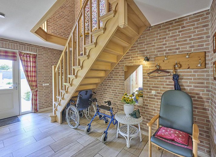 Covered terrace of Lionshuis vacation home in Panningen, Limburg overlooking the garden.