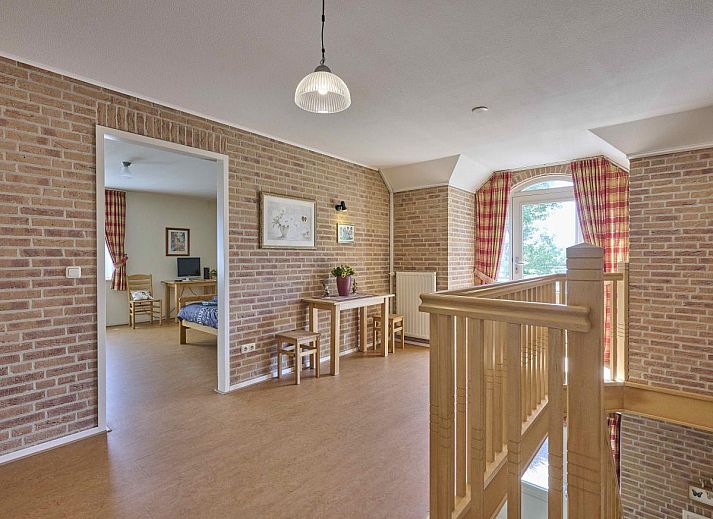 Covered terrace of Lionshuis vacation home in Panningen, Limburg overlooking the garden.