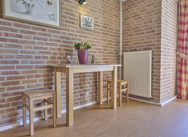 Covered terrace of Lionshuis vacation home in Panningen, Limburg overlooking the garden.