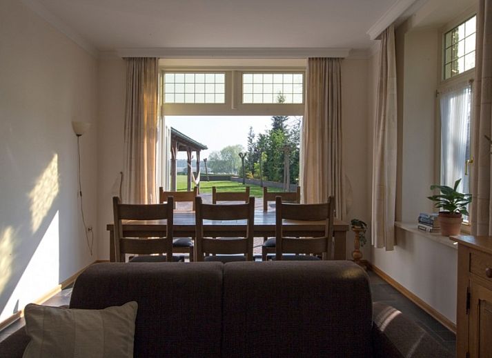 Cozy living room of Huize Stevens in Well, North Limburg, with comfortable seating and lots of natural light.