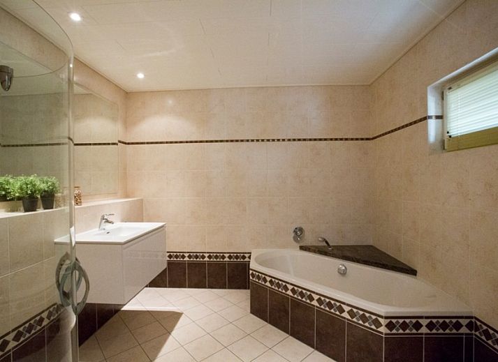 Cozy living room of Huize Stevens in Well, North Limburg, with comfortable seating and lots of natural light.