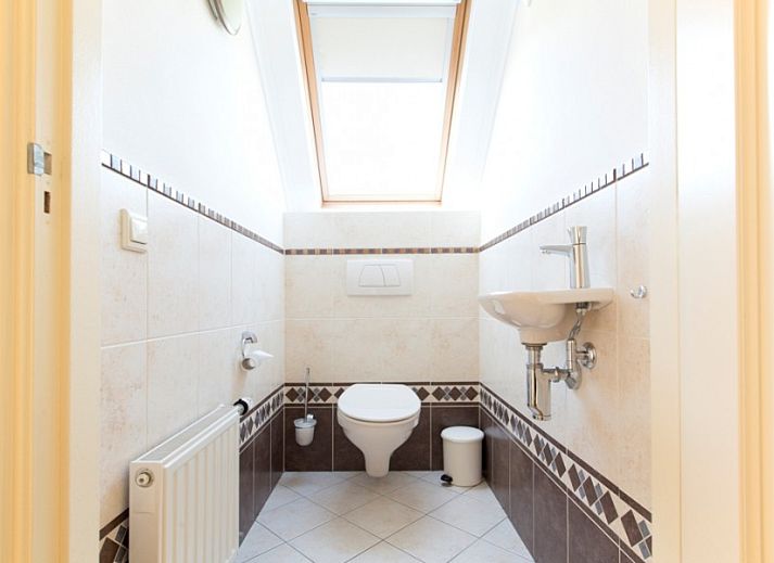 Cozy living room of Huize Stevens in Well, North Limburg, with comfortable seating and lots of natural light.
