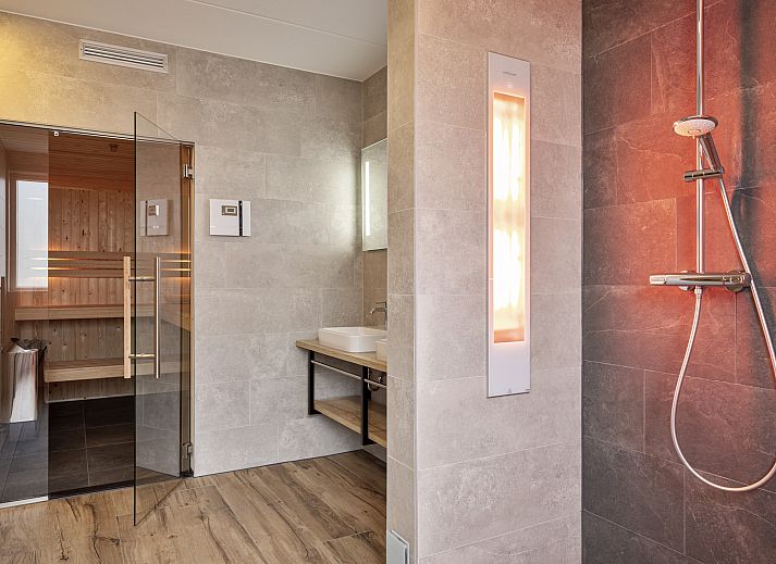 Relax in the luxurious bathroom of the 12-person wellness villa 12ELW in Well, North Limburg.