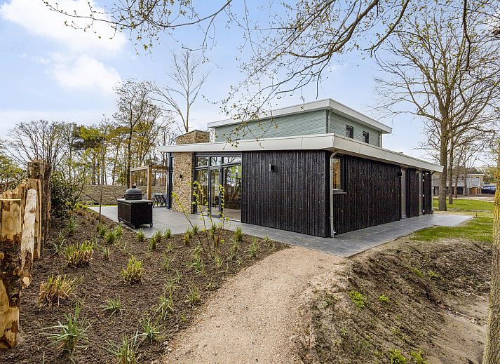 Spacious dining room and kitchen in the 12-person wellness villa 12ELW in Well, North Limburg.
