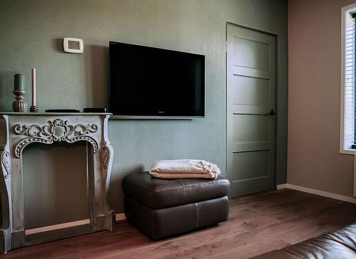 Gezellig terras bij Vakantiehuis in Well, Noord Limburg met eettafel en bloemen.