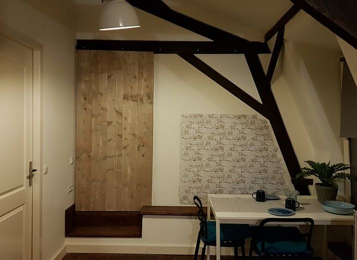 Comfortabele woonkamer in Huisje in Well, vakantiehuis in Well, Limburg, met gezellige zithoek en decoratieve planten.