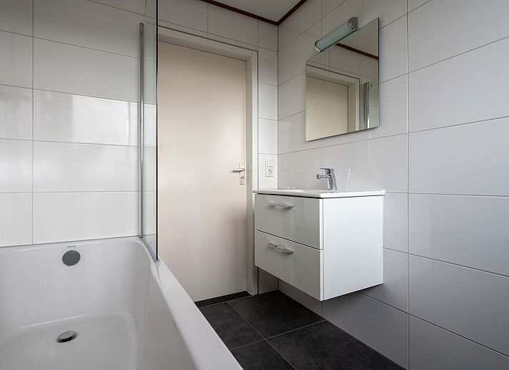 Gezellige woonkamer in de Vrijstaande woning in Arcen, Noord Limburg, met comfortabele banken en uitzicht op de groene tuin.