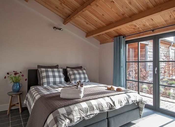 Wrought iron gate overlooking the garden at Holiday home in Afferden, Limburg.