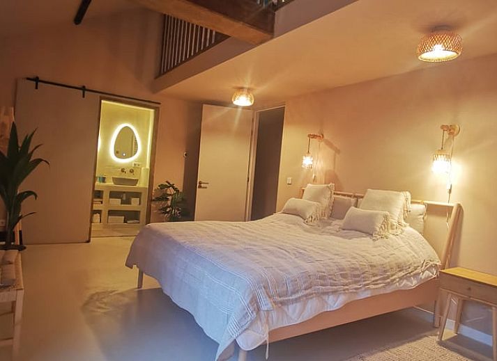 Cozy bedroom in Holiday Home in America, North Limburg, with rustic decor and warm lighting.