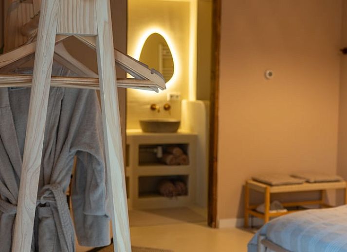Cozy bedroom in Holiday Home in America, North Limburg, with rustic decor and warm lighting.