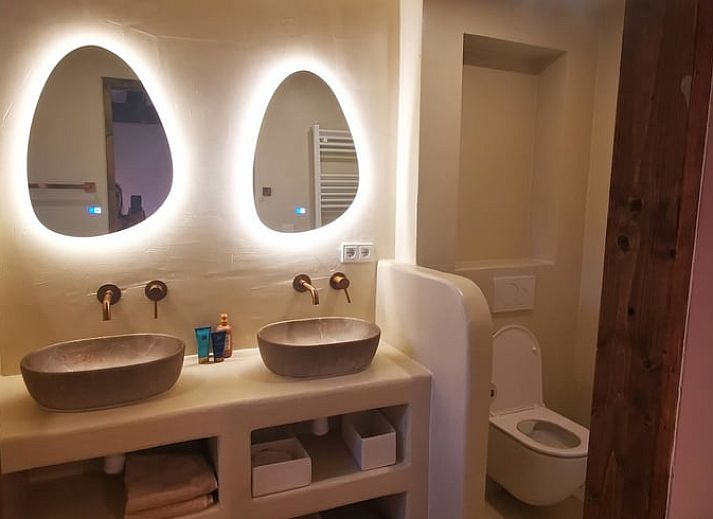 Cozy bedroom in Holiday Home in America, North Limburg, with rustic decor and warm lighting.