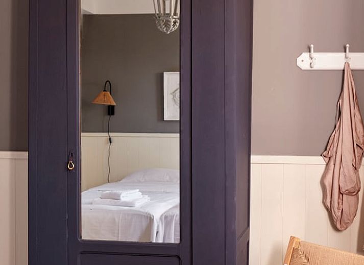 Detail van elegante salontafel in Huisje in Baarlo, Baarlo, met bloemen en boeken.