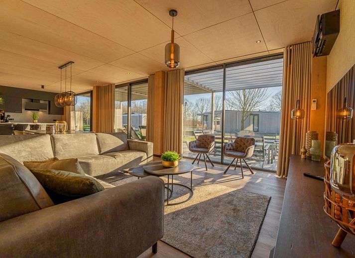 Luxury living room of Bos Villa in Maasbree, North Limburg, vacation home for 8 people overlooking terrace and nature.