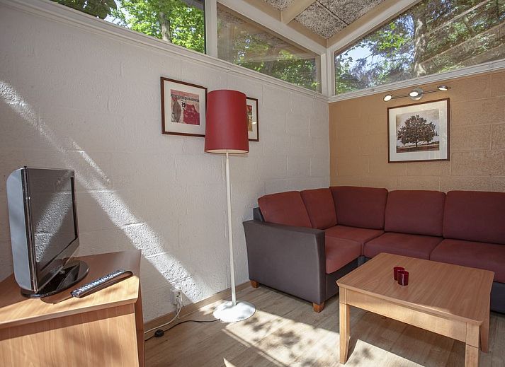 Cozy living room in De Lommerbergen 2-bed bungalow in Reuver, North Limburg overlooking the terrace.