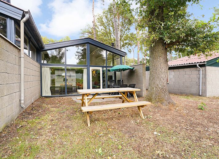 Cozy living room with fireplace in De Lommerbergen 4-person children's bungalow, Reuver, North Limburg. Perfect for family time.