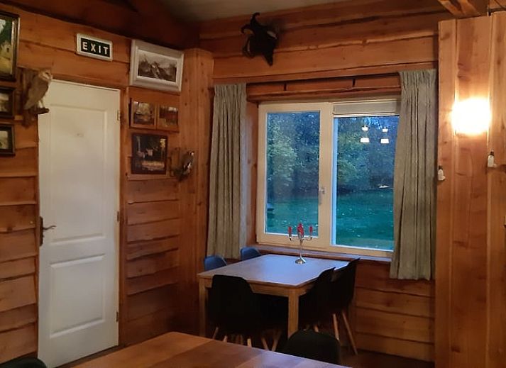 Hunting-themed decor in Holiday home in Sevenum, North Limburg, with deer antlers and rifle.