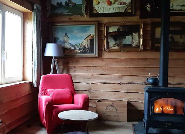 Hunting-themed decor in Holiday home in Sevenum, North Limburg, with deer antlers and rifle.
