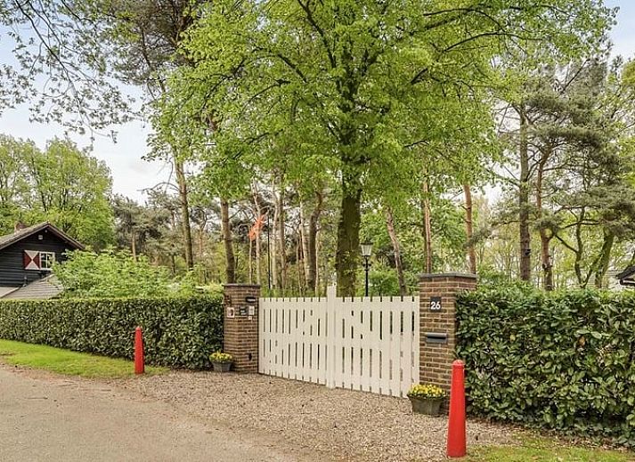 Entrance to Holiday Home in Heythuysen, North Limburg, surrounded by lush nature and green trees for a serene vacation experience.