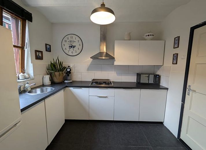 Nice reading corner in Holiday Home in Maastricht, South Limburg with books and a comfortable chair.
