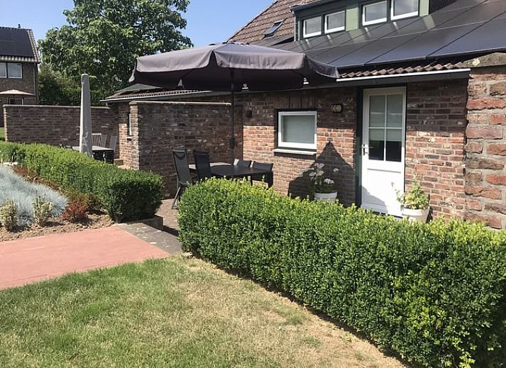 Gezellige binnenruimte van Vakantiehuisje in Heijenrath, Zuid Limburg met houten trap en stijlvolle meubels.