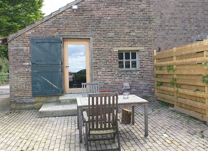 Cozy living room in Holiday home in Heijenrath, South Limburg. Authentic atmosphere with wooden beams and comfortable seating area.