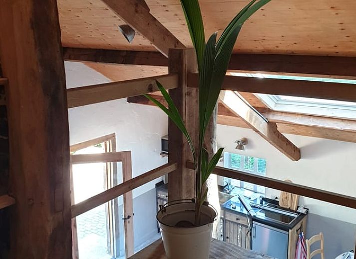 Cozy living room in Holiday home in Heijenrath, South Limburg. Authentic atmosphere with wooden beams and comfortable seating area.