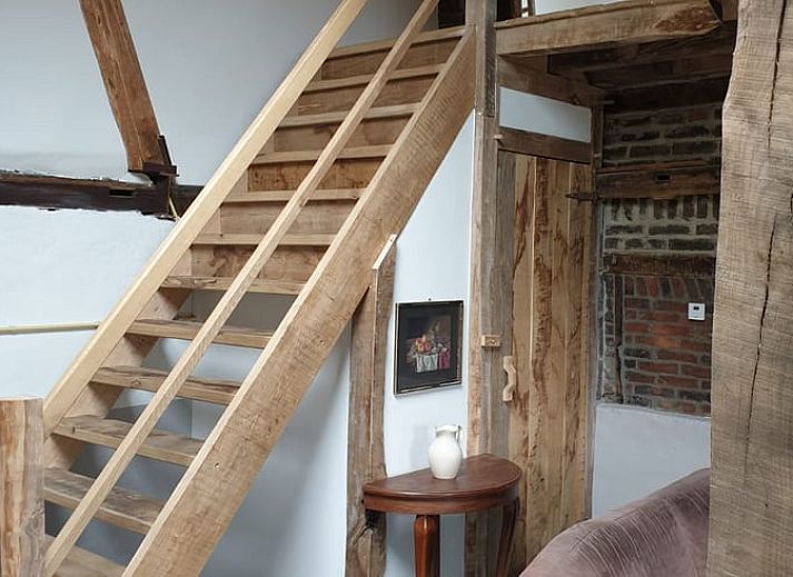 Cozy living room in Holiday home in Heijenrath, South Limburg. Authentic atmosphere with wooden beams and comfortable seating area.