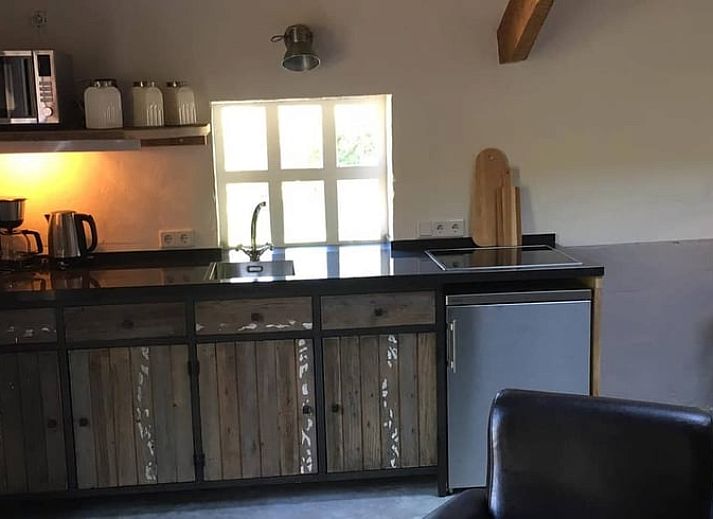 Cozy living room in Holiday home in Heijenrath, South Limburg. Authentic atmosphere with wooden beams and comfortable seating area.