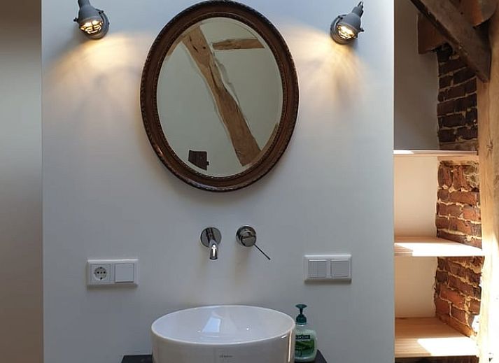 Bright interior of Holiday Home in Heijenrath, South Limburg. Modern kitchen with wooden elements and lots of natural light.