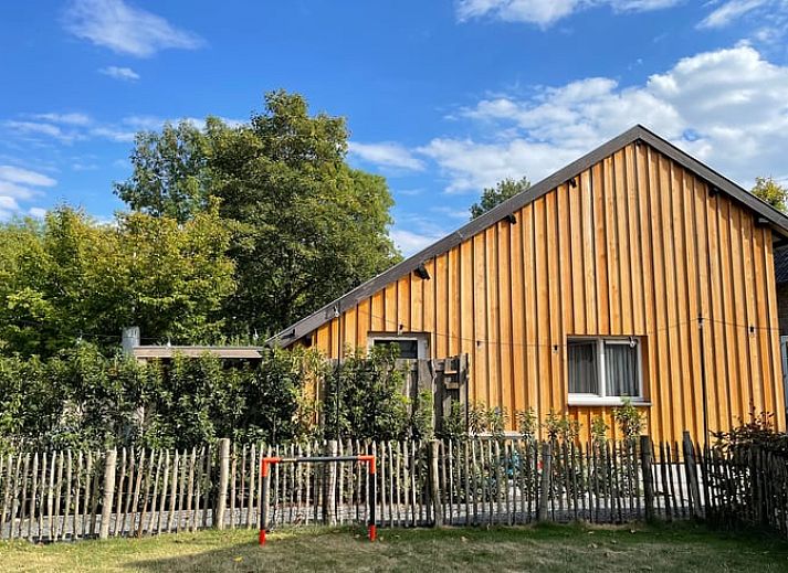 Enjoy the sunny veranda at Huisje in Schin op Geul, a charming vacation home in South Limburg.