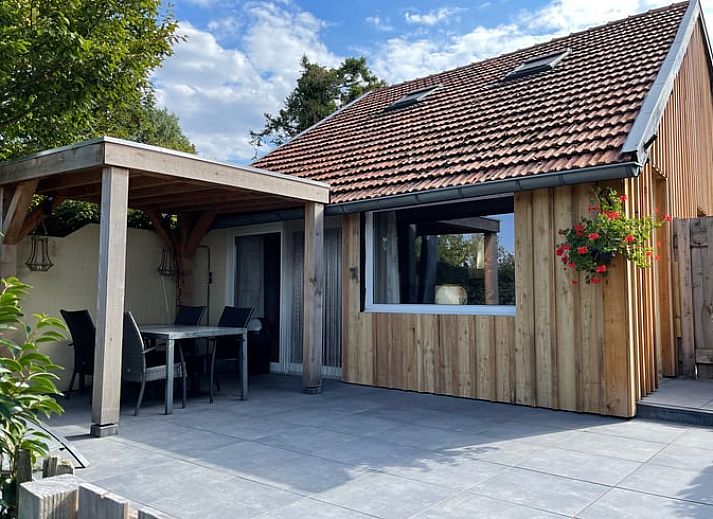 Enjoy the sunny veranda at Huisje in Schin op Geul, a charming vacation home in South Limburg.