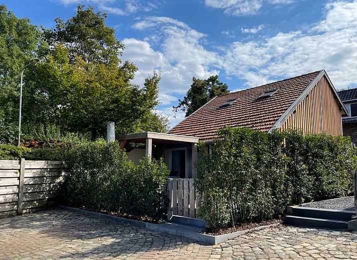 Enjoy the sunny veranda at Huisje in Schin op Geul, a charming vacation home in South Limburg.