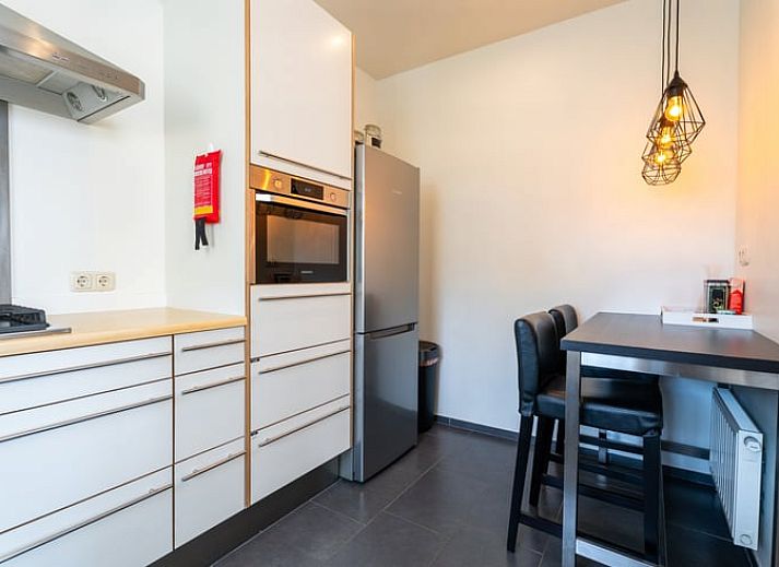 Stylish living room of Holiday home in Klimmen, South Limburg, with wooden floor and modern interior.